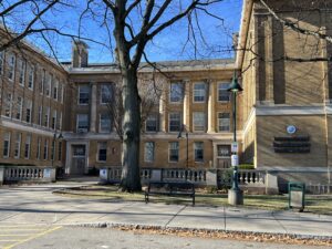 A large building with a tree in front of it.