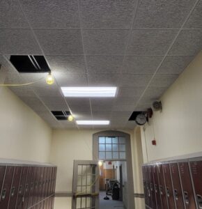 A hallway with lockers and a door.