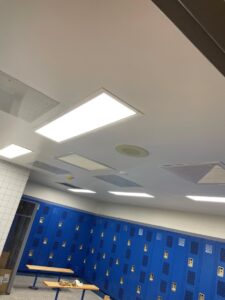 A room with blue lockers and lights.