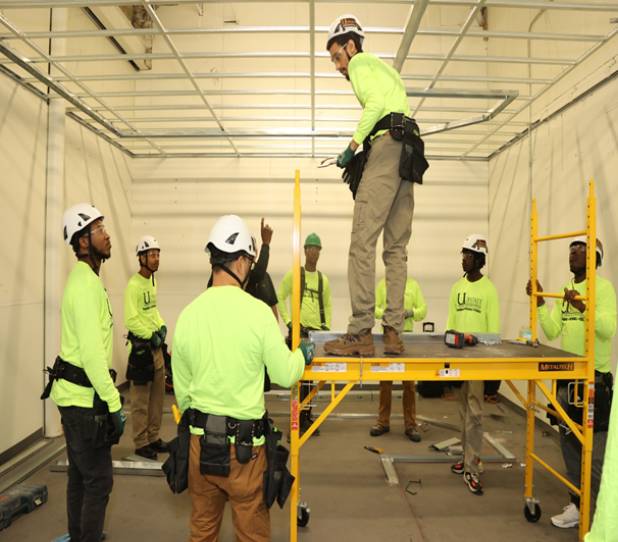 A group of construction workers standing in a room.