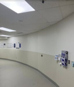 A hallway in a hospital with a lot of equipment.