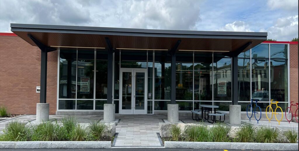 The entrance to a building with a metal roof.