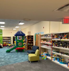 A children's play area with toys and books.