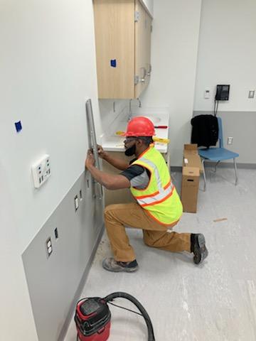 Man using measuring tool on wall