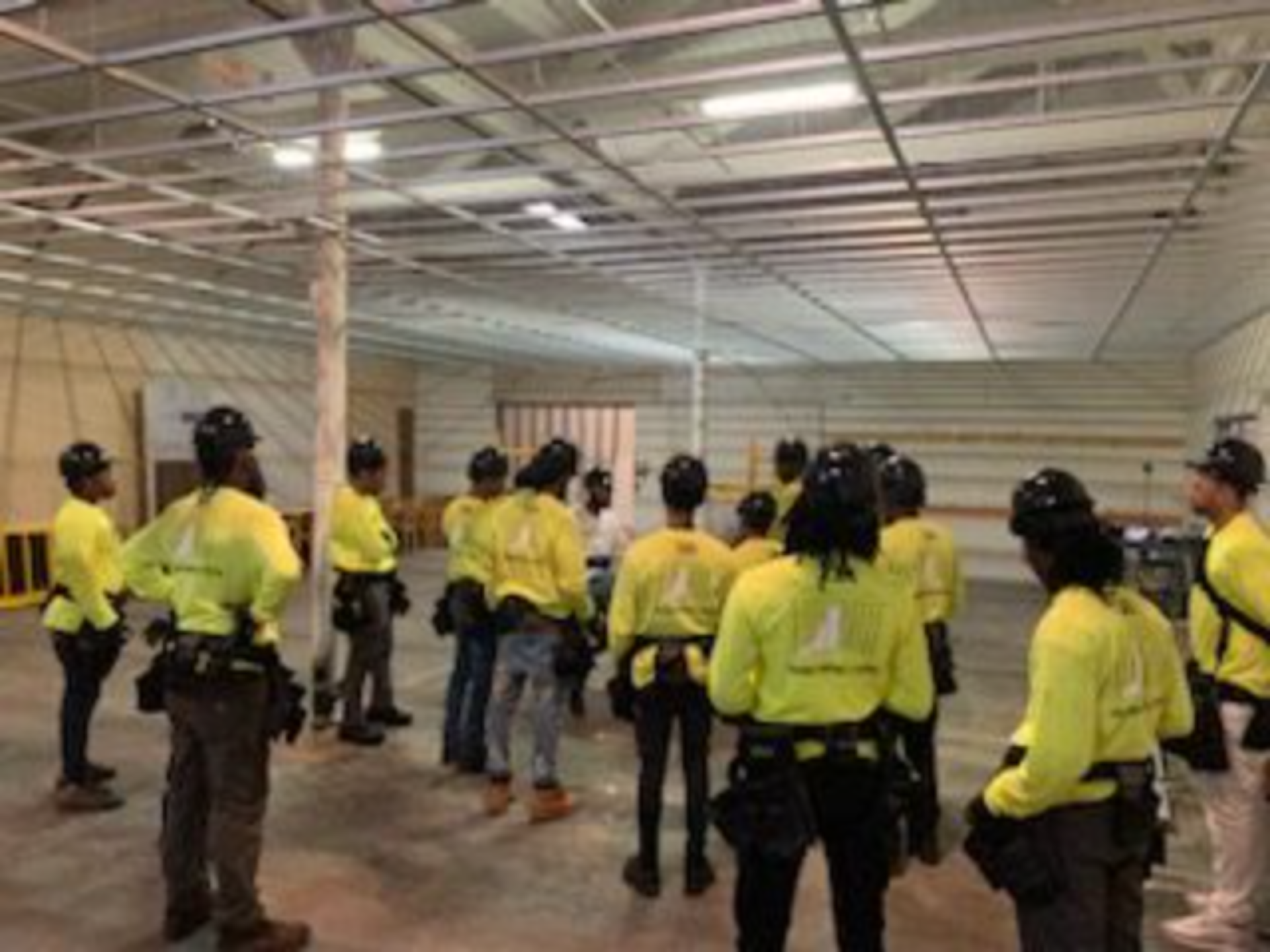 Construction workers gathering in a large room