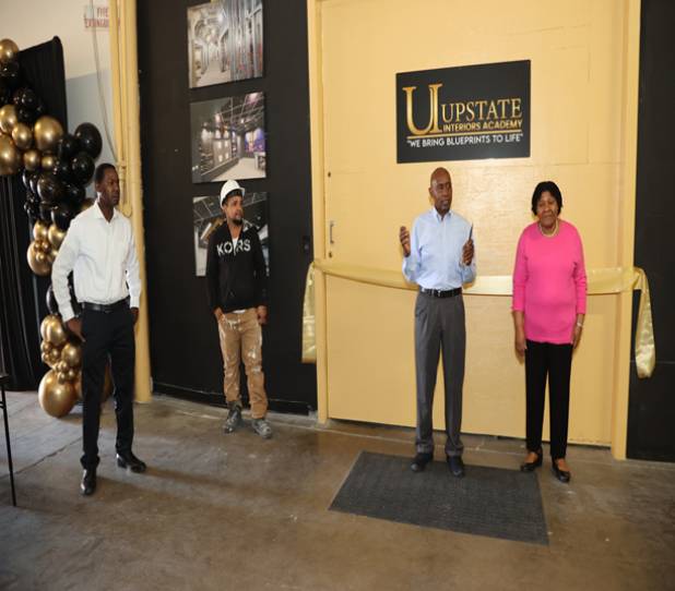 Group standing in front of academy entrance