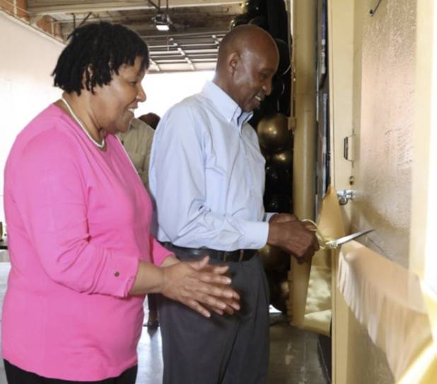 Man cutting ribbon at event