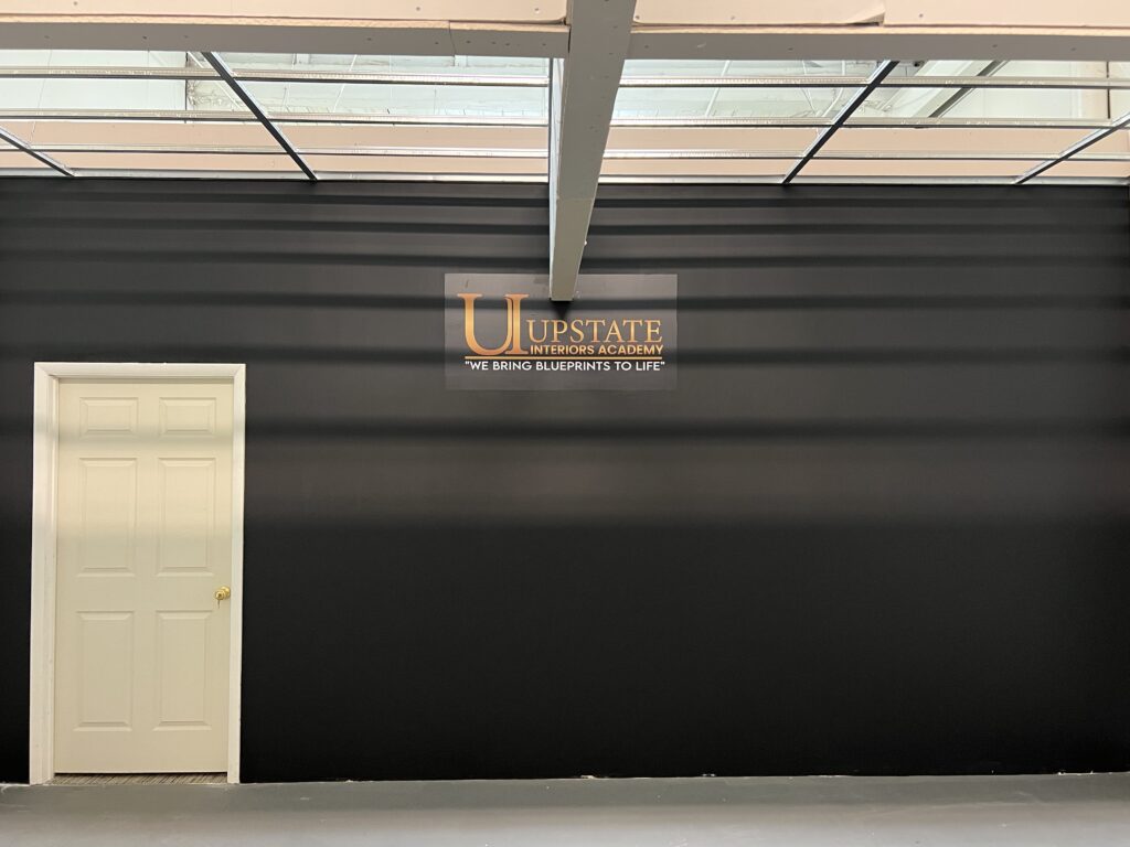 Door and sign on black wall