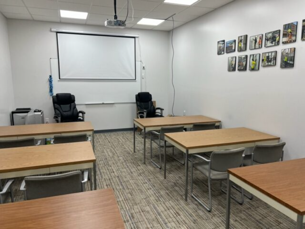 Classroom setup with tables and screen