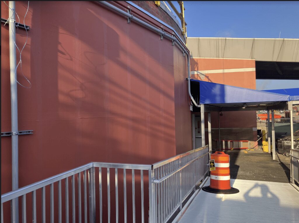 Building exterior with metal railing and cone