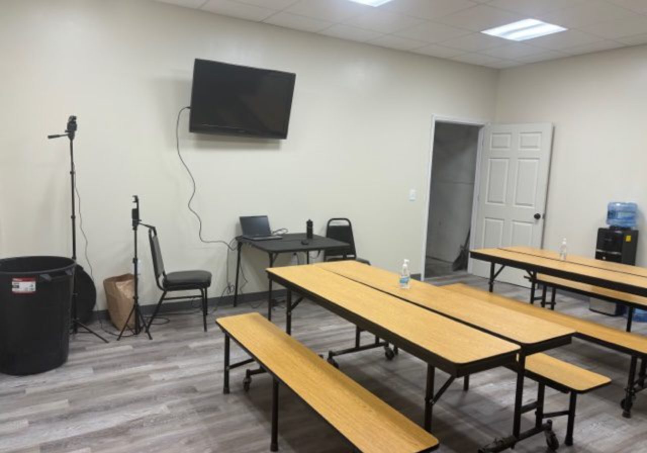 Empty break room with tables and chairs.